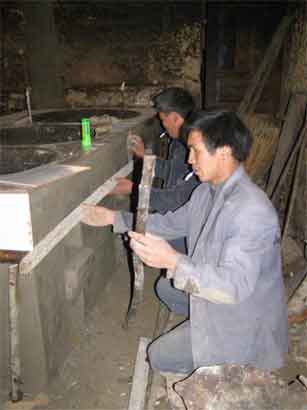 Wanlin apprentice villager working on a stove and trainer (back)